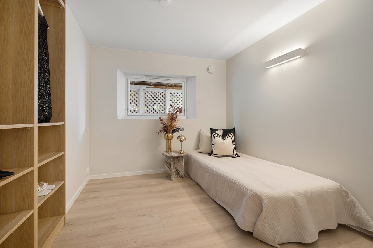 Bedroom with a Single Bed and Wooden Shelves